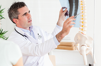 Male Doctor showing a patient a x-ray